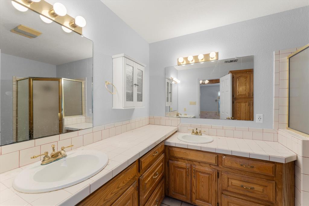 410 Etheridge Road Canton, TX 75103 - Photo 21 of 22 Bathroom with vanity, a shower stall, and decorative backsplash