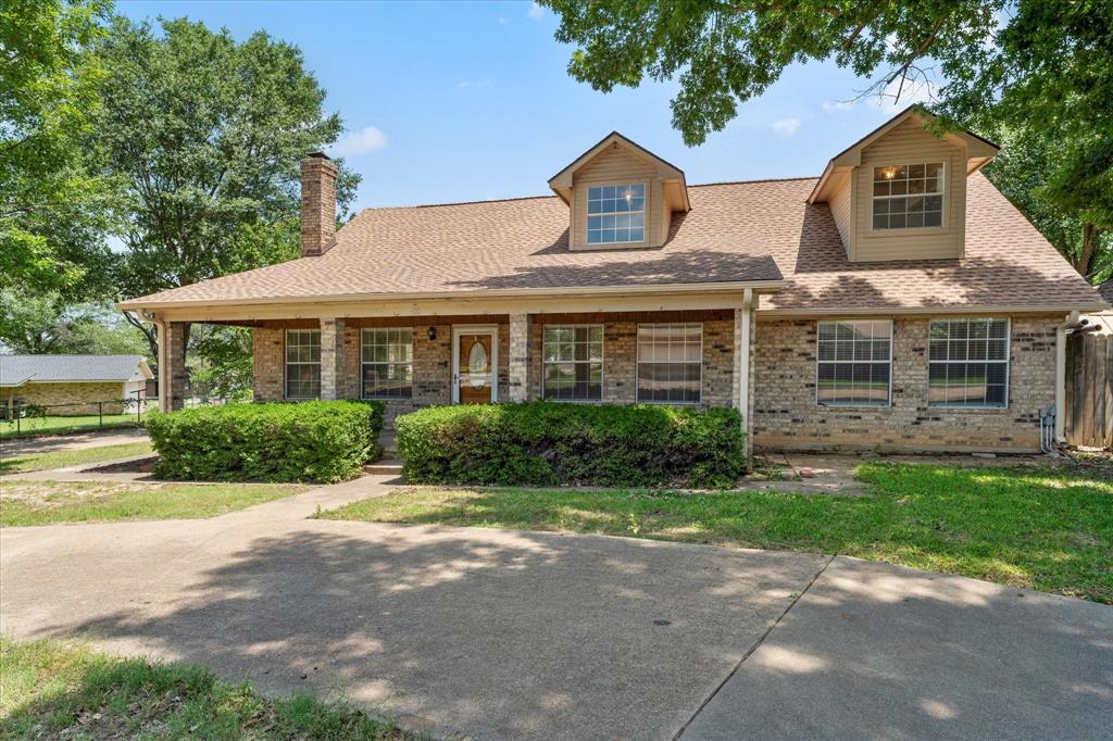 410 Etheridge Road Canton, TX 75103 - Photo 22 of 22 View of front of house featuring brick siding, a chimney, roof with shingles, and covered porch