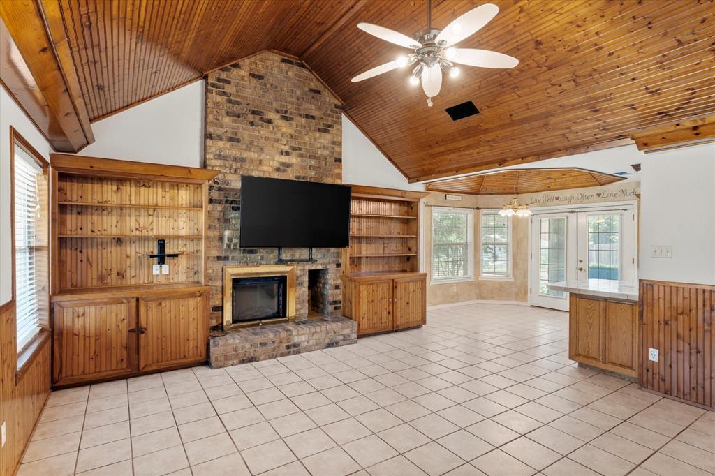 410 Etheridge Road Canton, TX 75103 - Photo 6 of 22 Unfurnished living room with wood ceiling, a fireplace, high vaulted ceiling, ceiling fan, and light tile patterned floors