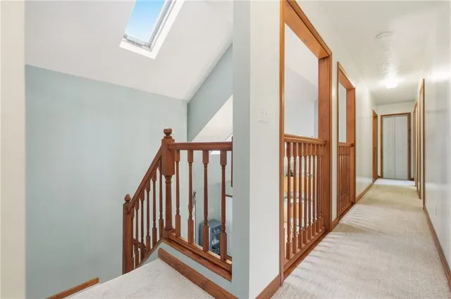 a bedroom with a bed a mirror and dresser with wooden floor