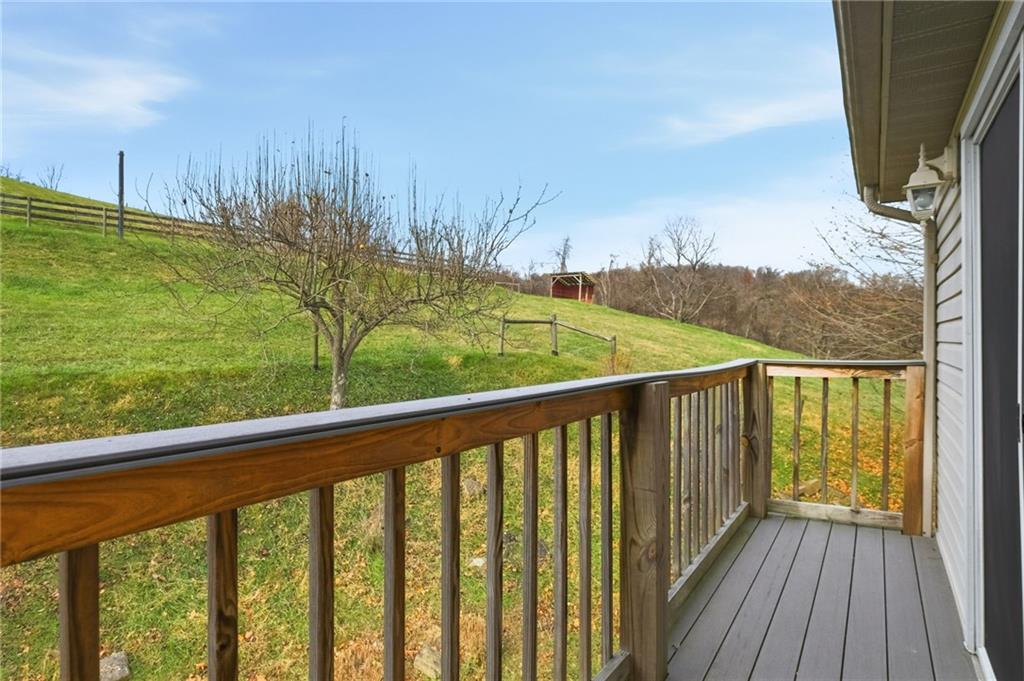 327 Sugar Run Road Waynesburg, PA 15370 - Photo 17 of 29 a view of a balcony with wooden floor and a yard