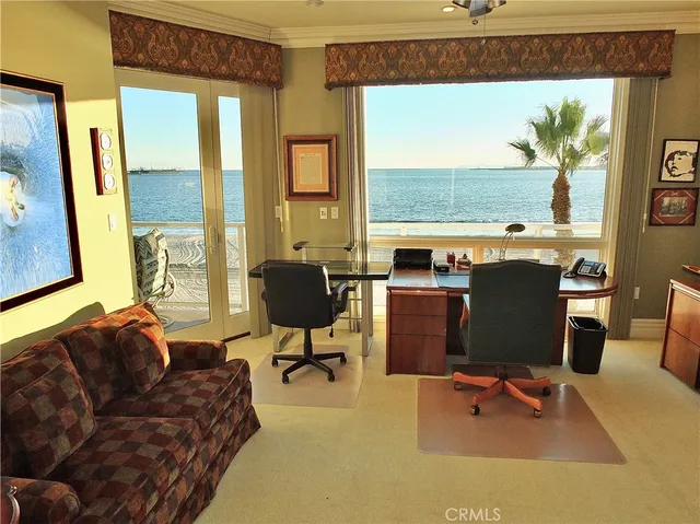 a living room with furniture a fireplace and a large window