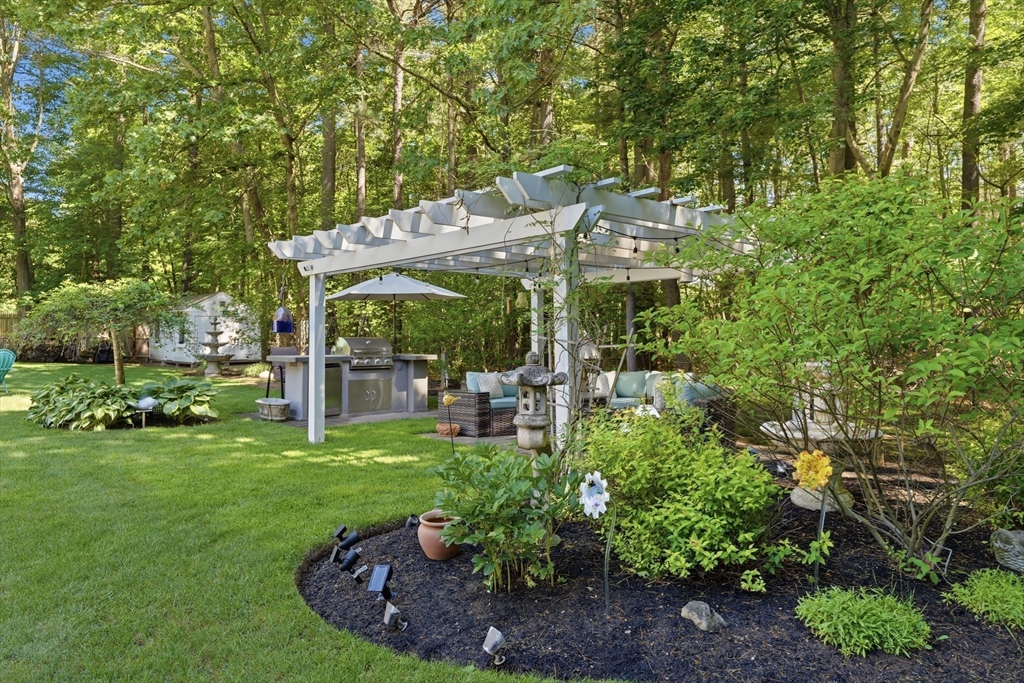 25 Haymeadow Road Boxford, MA 01921 - Photo 37 of 42 a view of a patio with table and chairs potted plants and large trees