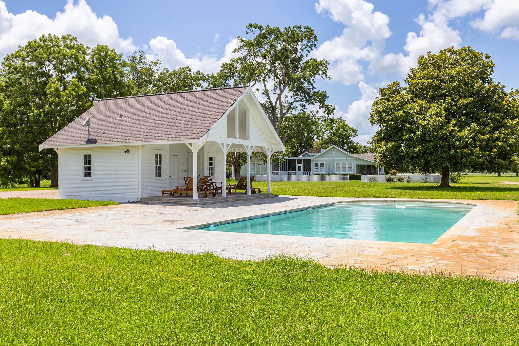 2908 Robichaux Road Pattison, TX 77423 - Photo 49 of 50 a view of a swimming pool with lawn chairs and plants