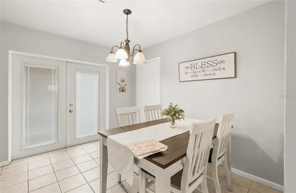 a view of a dining room with furniture and chandelier