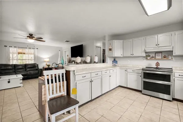 a kitchen with appliances cabinets and furniture