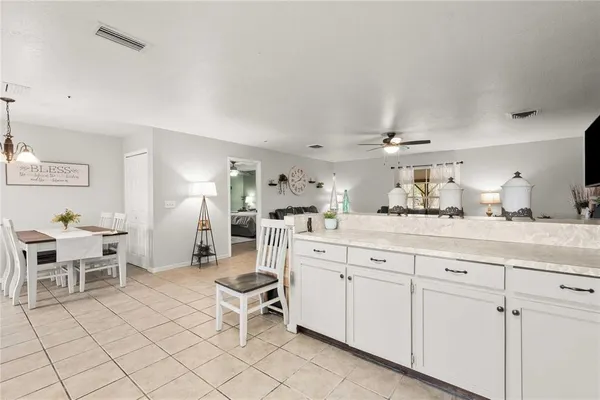 a room with white cabinets and chair