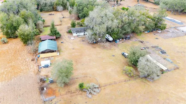 an aerial view of a house with a yard and sitting area