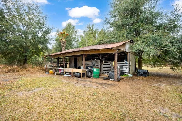 a view of a house with a yard and sitting area