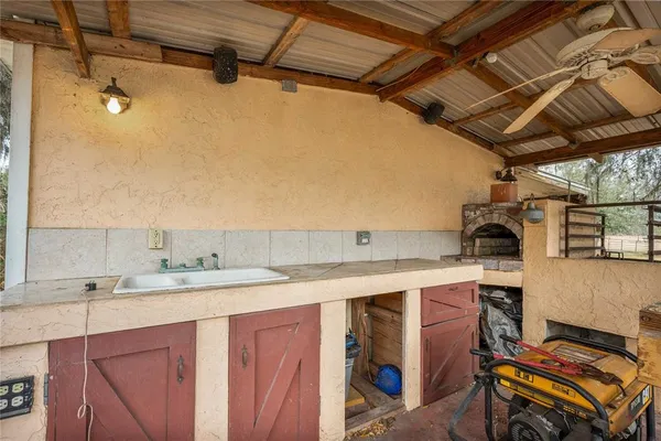 a view of a kitchen with a sink stainless steel appliances and cabinets