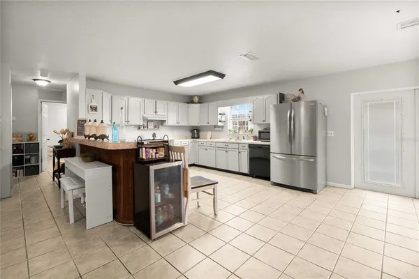 a kitchen with stainless steel appliances granite countertop a stove refrigerator sink and cabinets