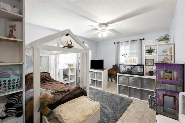 a bedroom with furniture and a flat screen tv