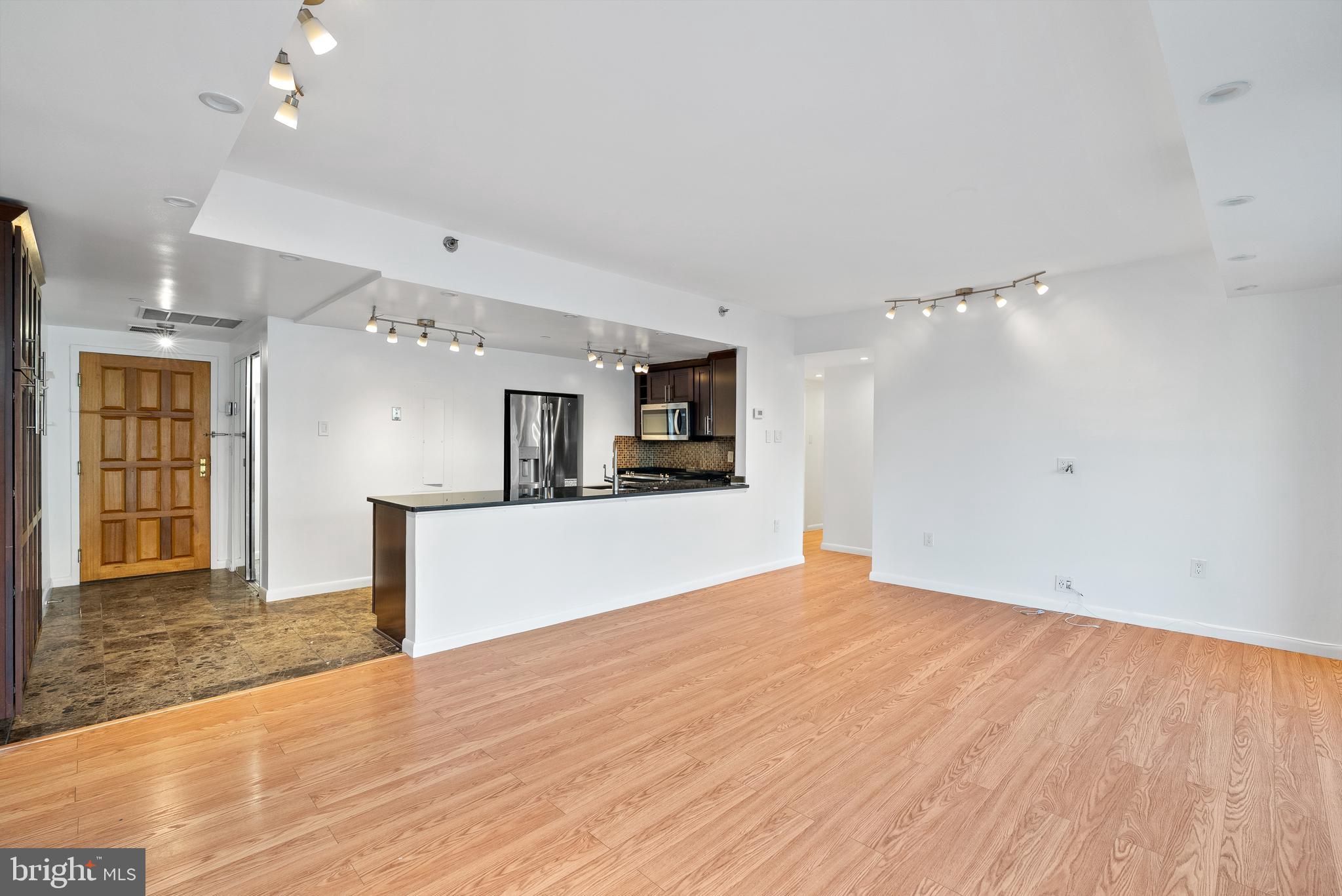 1530 Key Boulevard, Unit 930 Arlington, VA 22209 - Photo 6 of 20 a view of a kitchen with a sink and a refrigerator