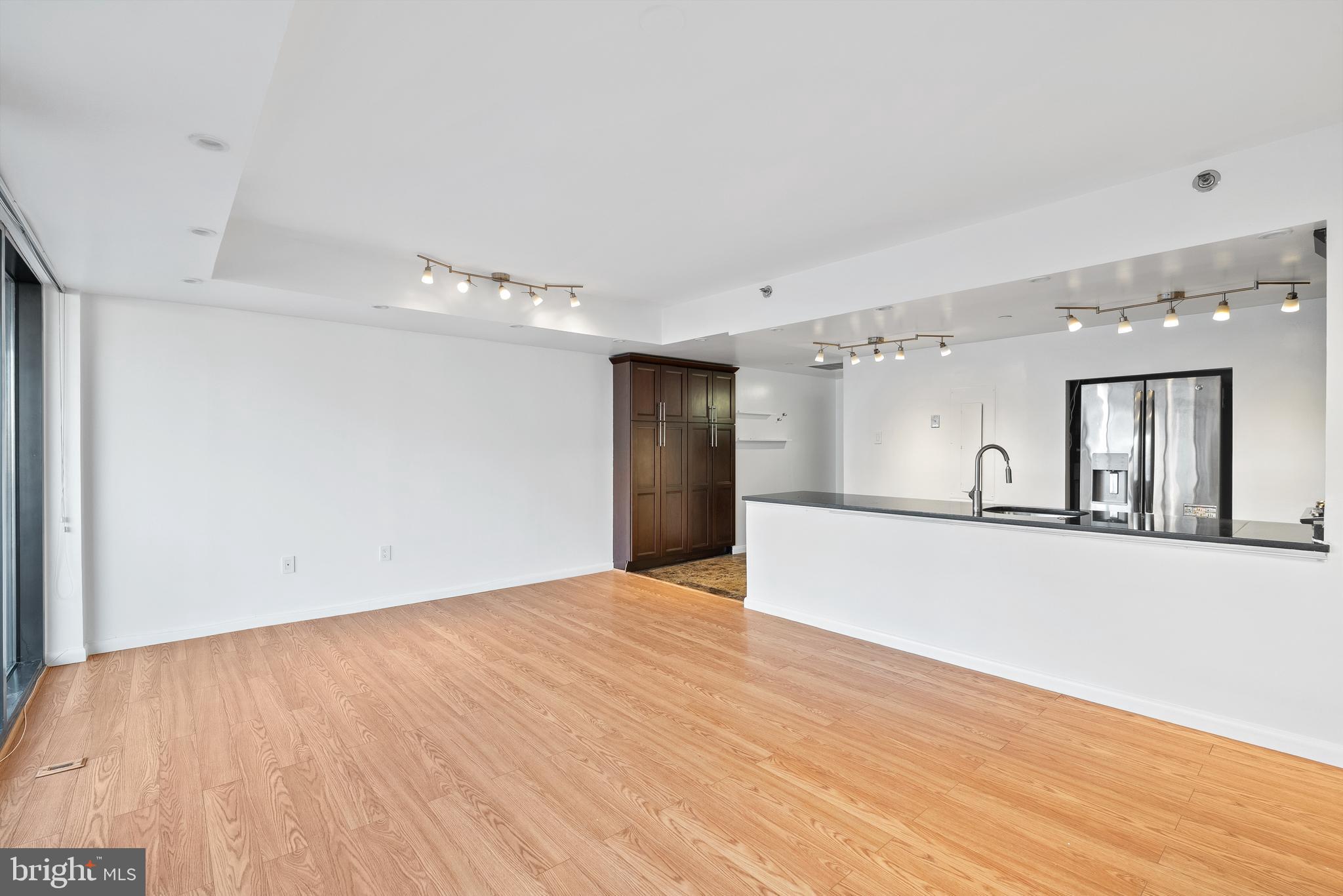 1530 Key Boulevard, Unit 930 Arlington, VA 22209 - Photo 7 of 20 a view of a kitchen with wooden floor and a window