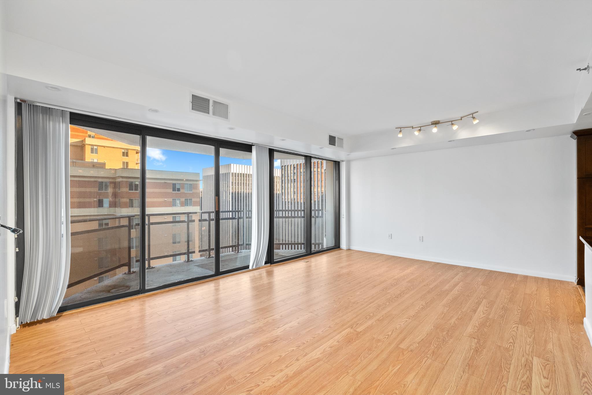 1530 Key Boulevard, Unit 930 Arlington, VA 22209 - Photo 9 of 20 a view of an empty room with glass door