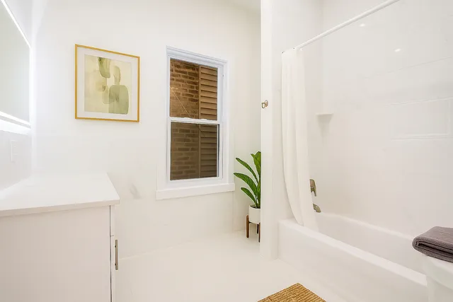 a bathroom with a bathtub and a window