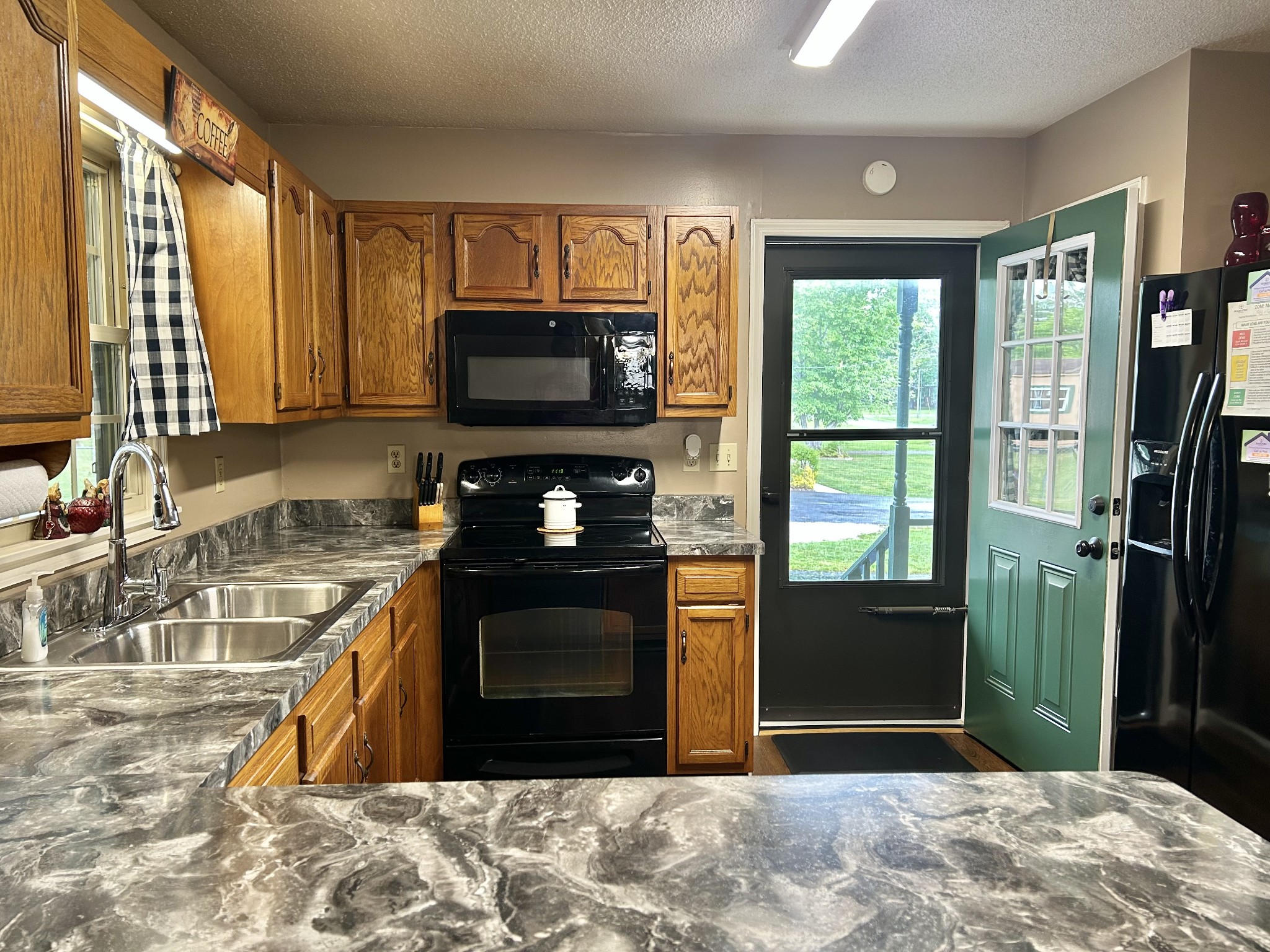 1306 McMahan Street Manchester, TN 37355 - Photo 18 of 48 a kitchen with a stove a sink and a microwave