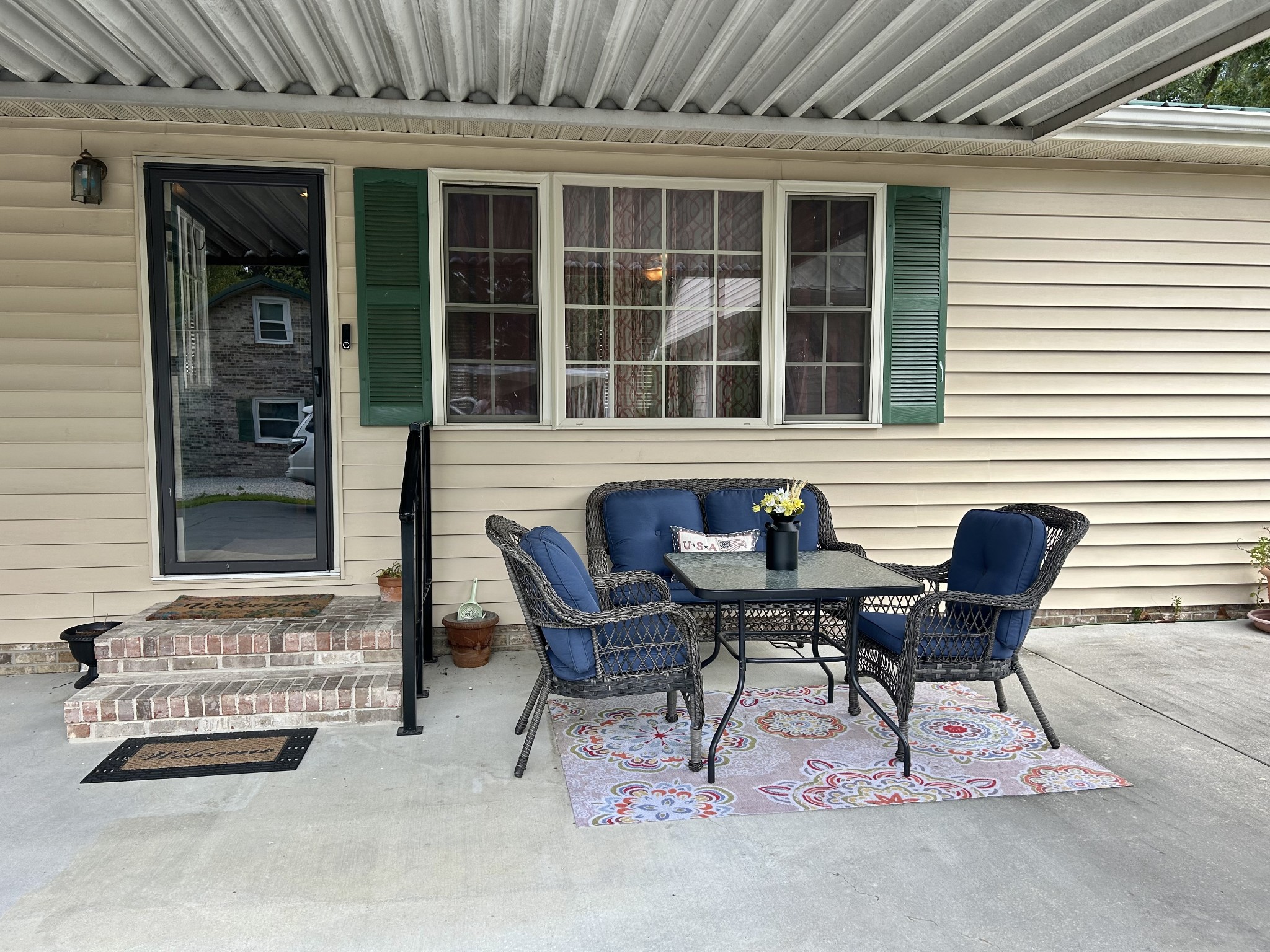 1306 McMahan Street Manchester, TN 37355 - Photo 39 of 48 a balcony with table and chairs and potted plants