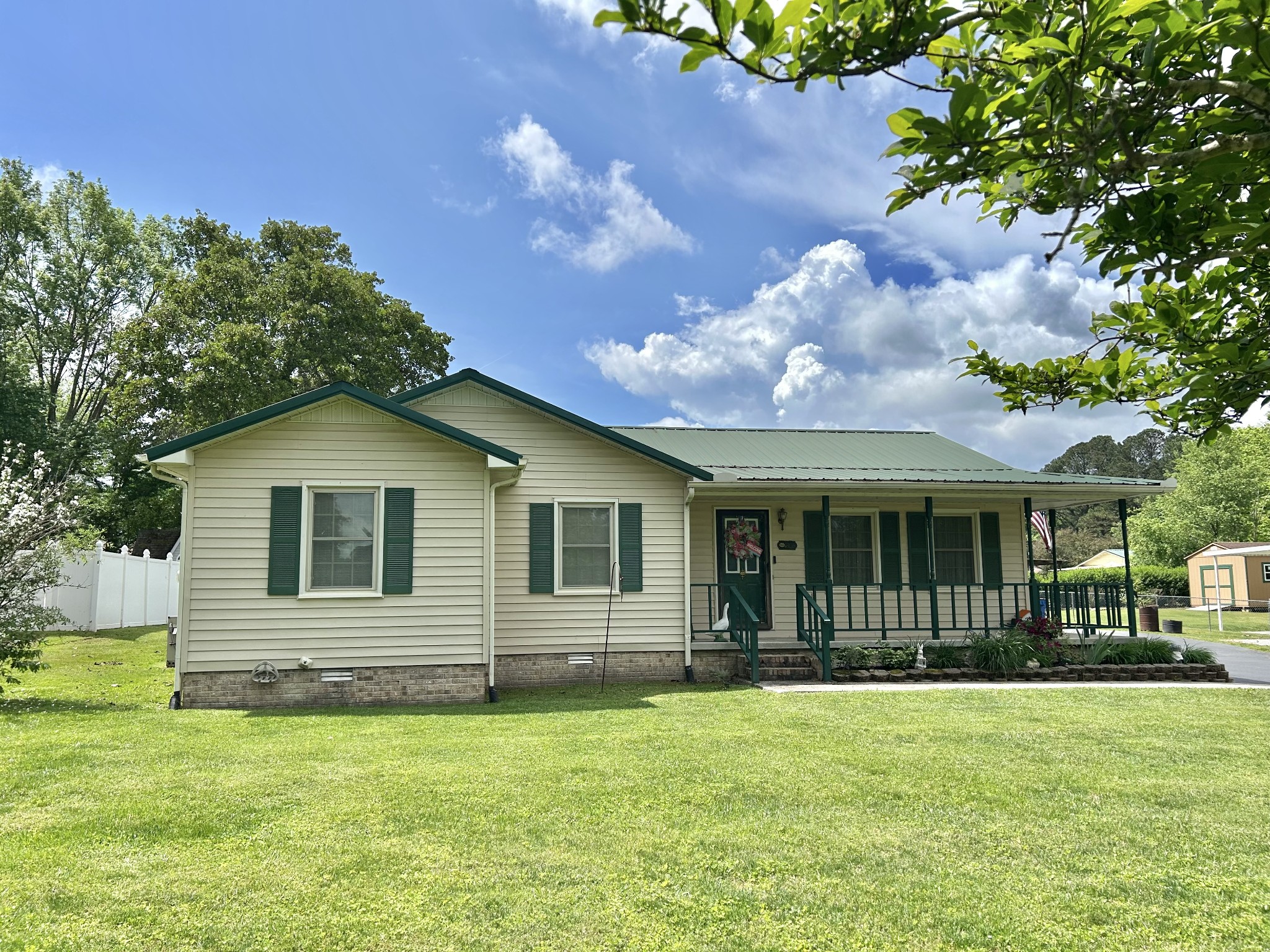 1306 McMahan Street Manchester, TN 37355 - Photo 4 of 48 a front view of a house with garden