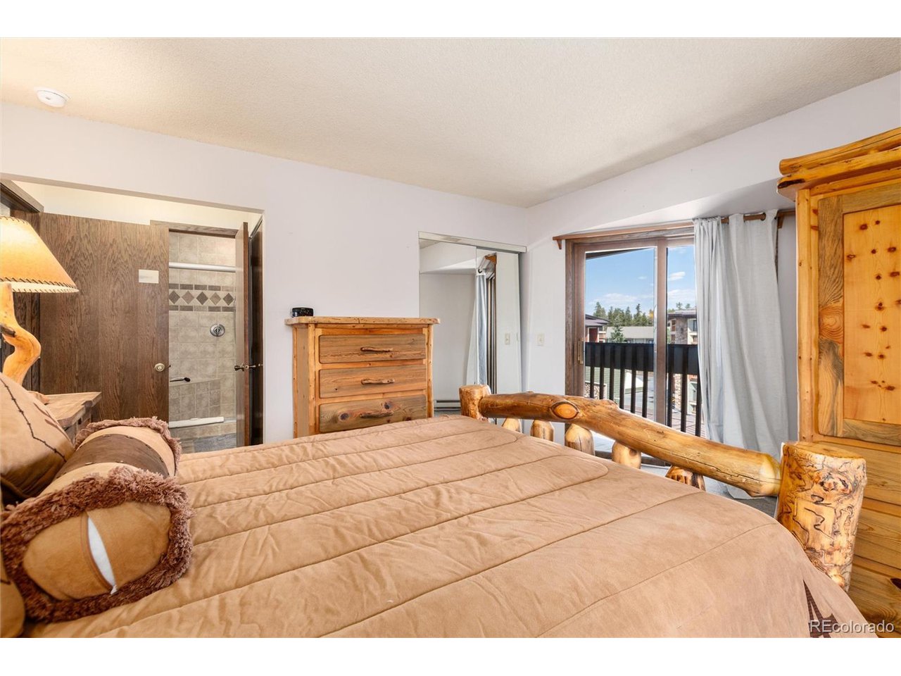 490 Kings Crossing Road, Unit 631 Winter Park, CO 80482 - Photo 27 of 43 a bedroom with a bed and a large mirror