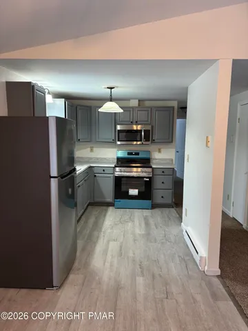 a view of empty room with a fireplace