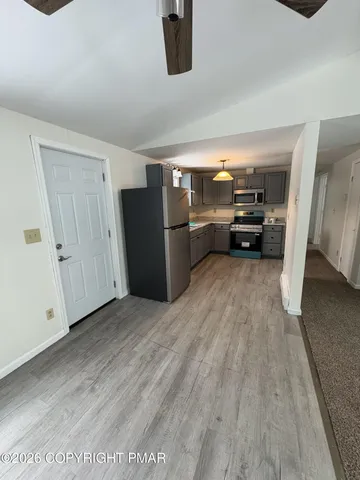 a kitchen with a refrigerator sink and cabinets