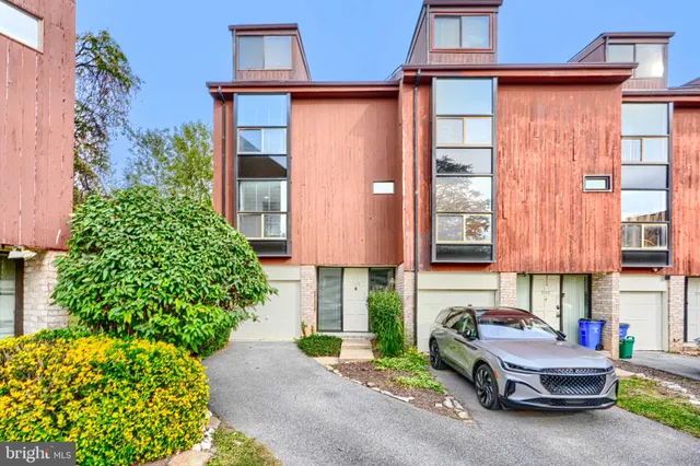 a view of backyard with outdoor seating and plants