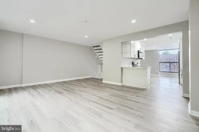 a view of empty room with wooden floor