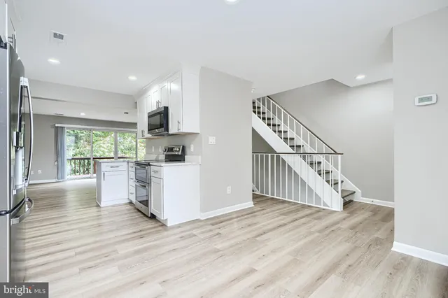 a view of kitchen with furniture and wooden floor