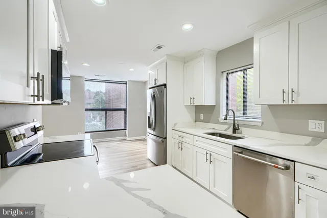 a kitchen with a sink stove and refrigerator