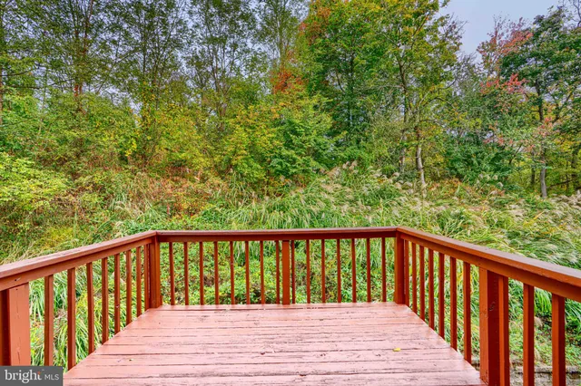 a balcony with wooden floor and fence