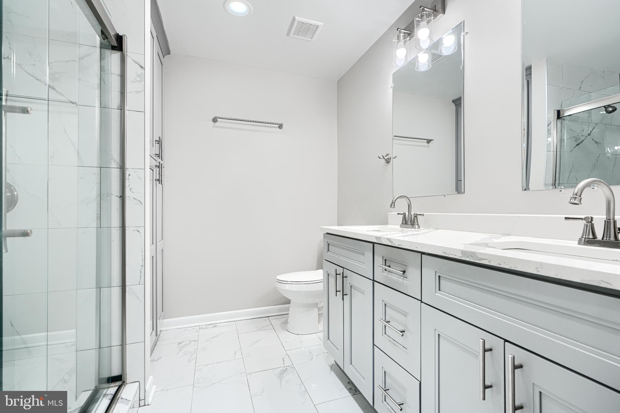 5520 Vantage Point Road Columbia, MD 21044 - Photo 22 of 28 a spacious bathroom with a double vanity sink a toilet and a mirror