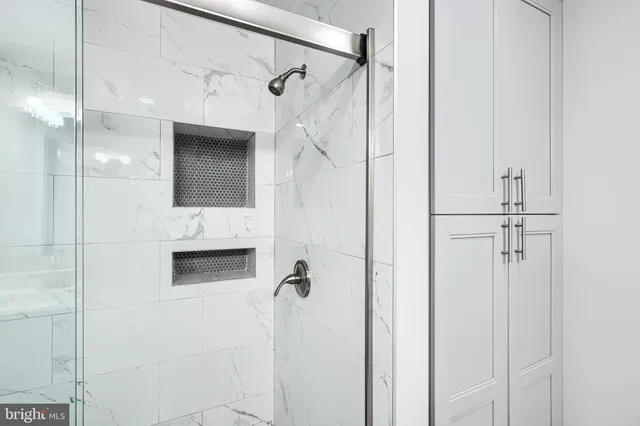 a bathroom with a shower and mirror