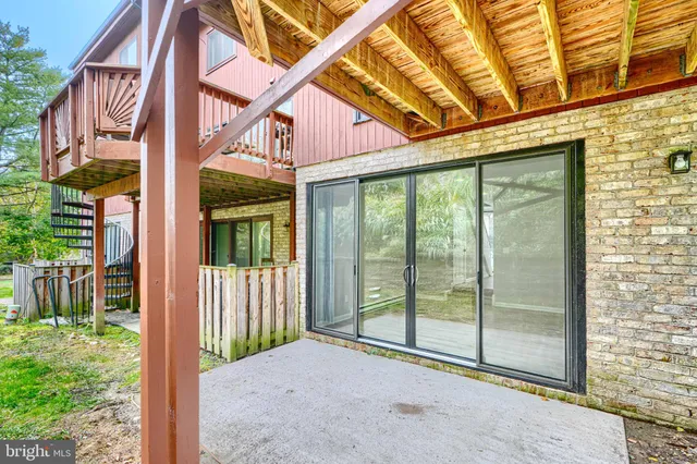 a view of backyard with large windows and plants