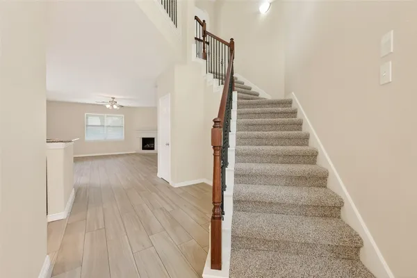 a view of entryway and hall with wooden floor