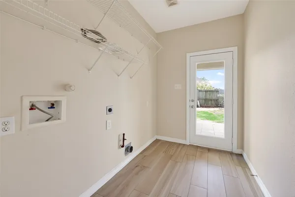 a view of a room with wooden floor closet and windows