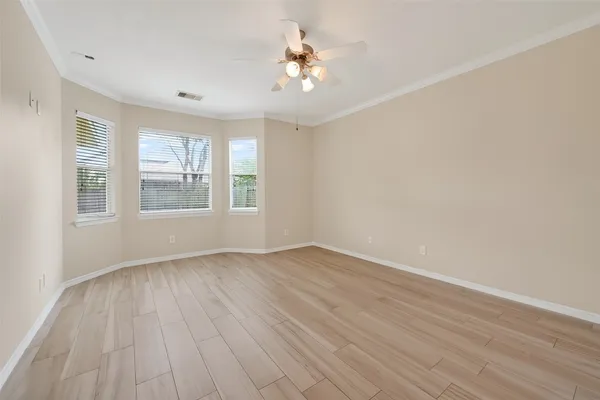wooden floor in an empty room with a window
