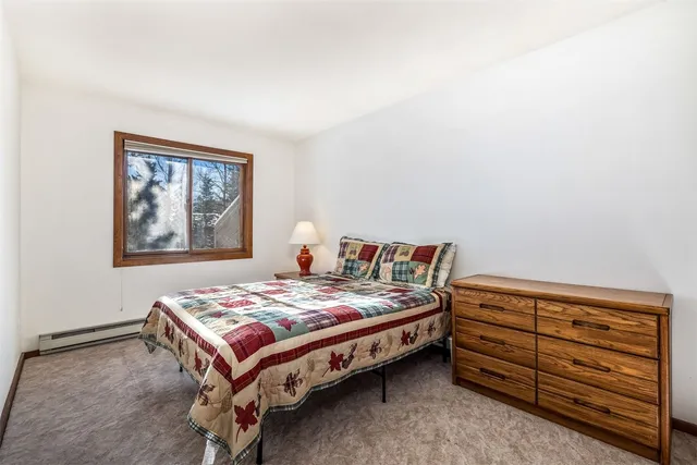 a bedroom with a bed and a lamp