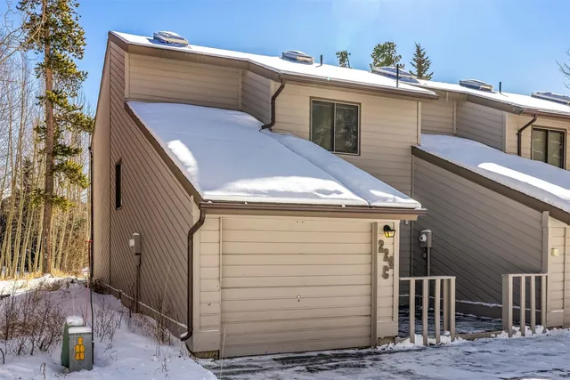 a view of a house with wooden fence