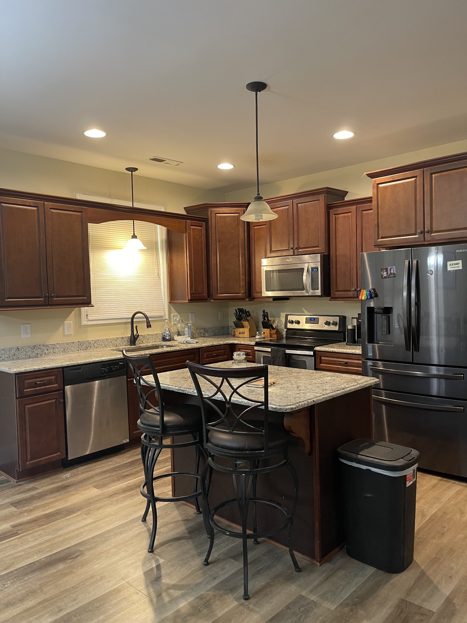 511 Franklin Road Gallatin, TN 37066 - Photo 15 of 47 a kitchen with stainless steel appliances granite countertop a sink dishwasher a stove a refrigerator and island with wooden floor