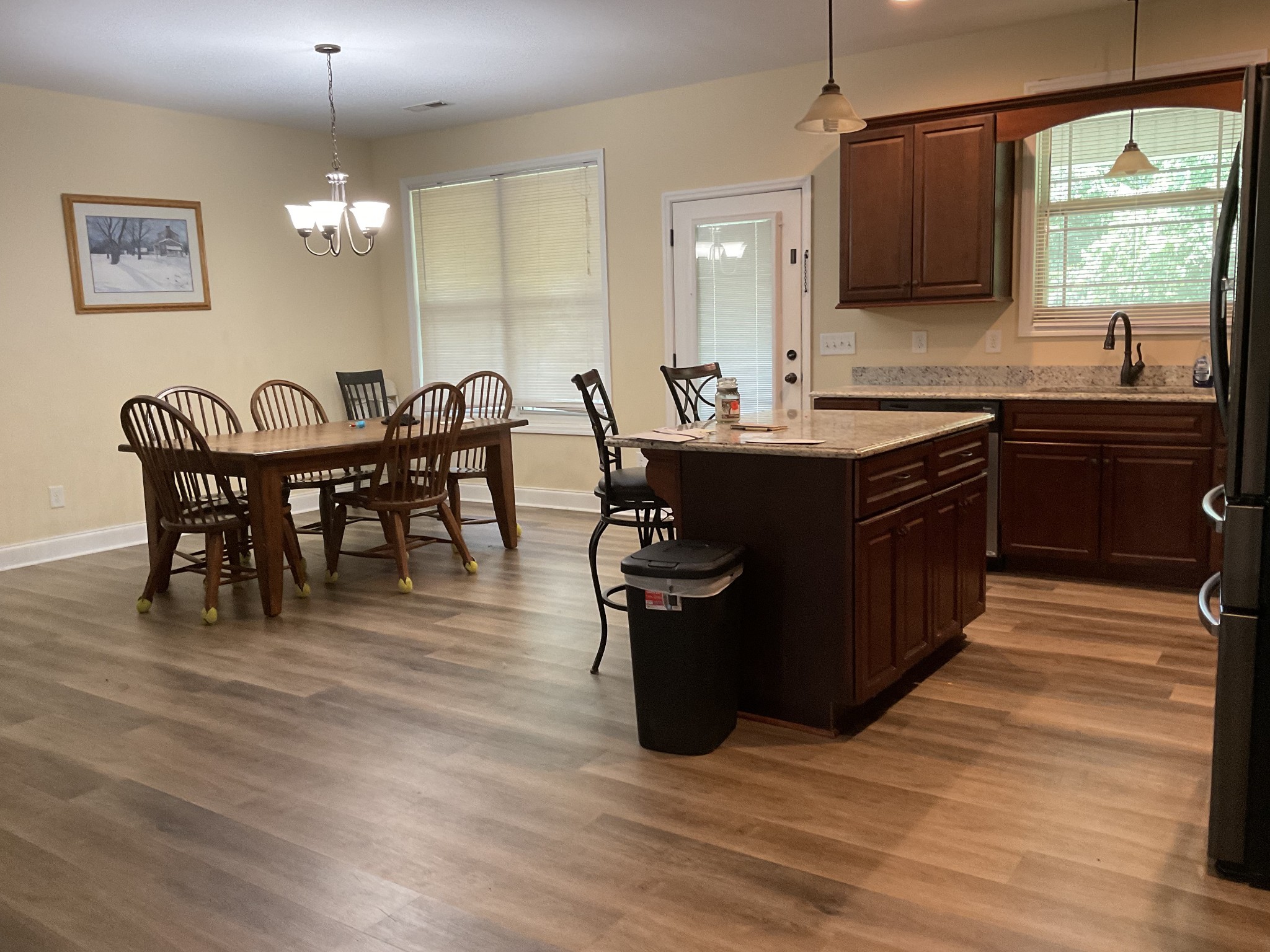 511 Franklin Road Gallatin, TN 37066 - Photo 4 of 47 a kitchen with stainless steel appliances granite countertop a table chairs and a refrigerator