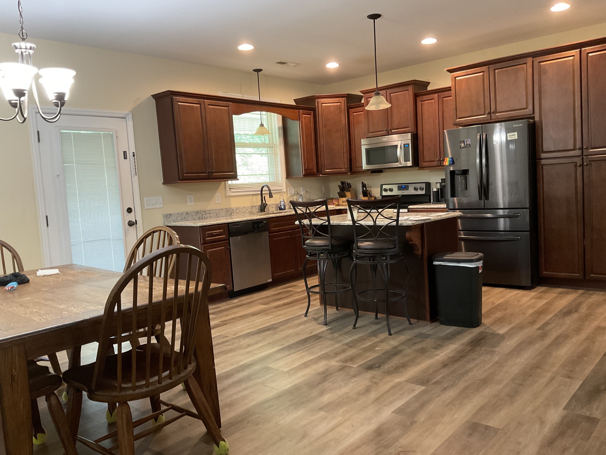 511 Franklin Road Gallatin, TN 37066 - Photo 5 of 47 a kitchen with stainless steel appliances granite countertop a stove a refrigerator a kitchen island a dining table and chairs