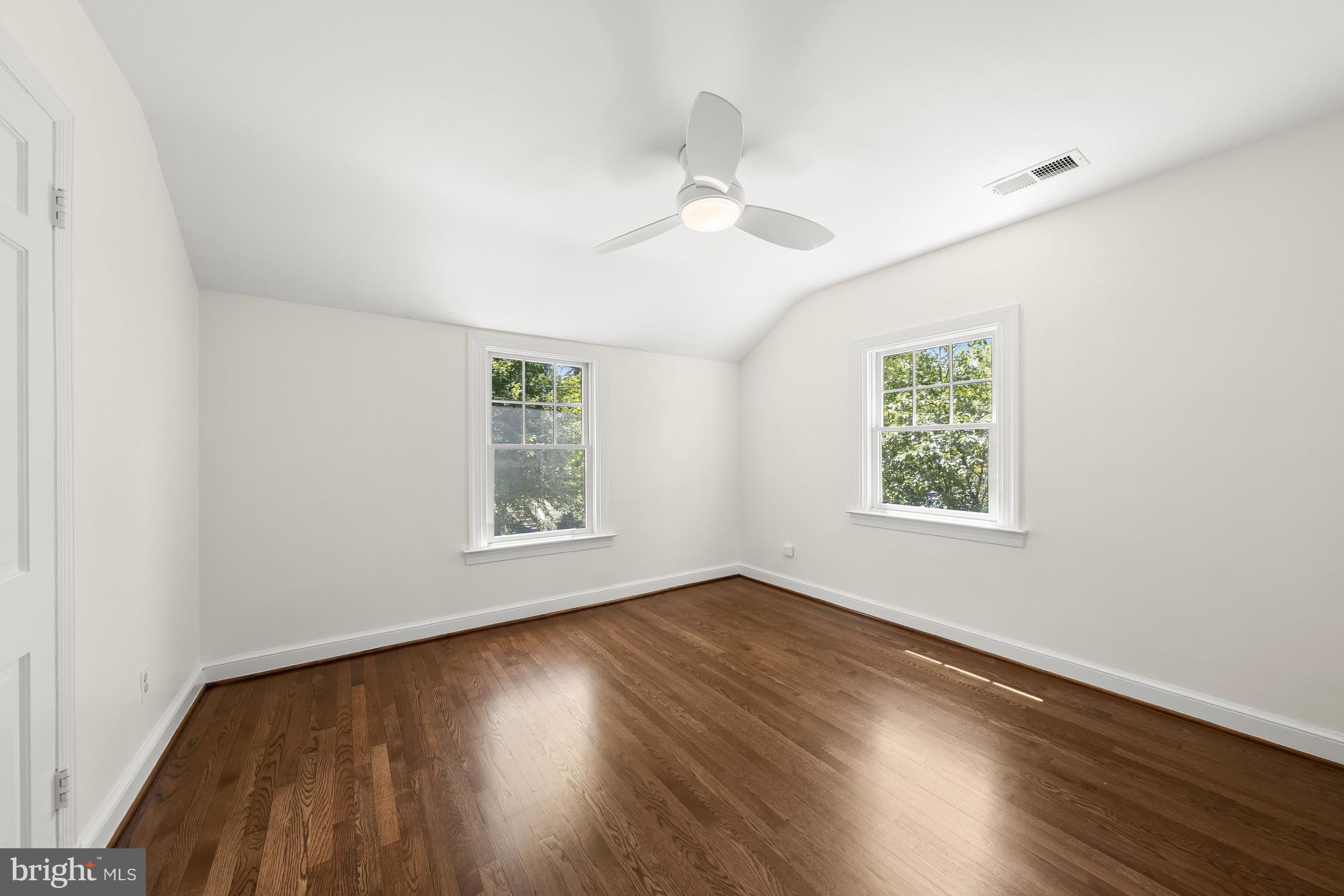 8800 Maywood Avenue Silver Spring, MD 20910 - Photo 28 of 41 a view of an empty room with wooden floor and a window