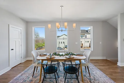 a view of a dining room with furniture window and wooden floor
