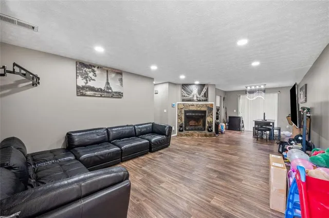 a living room with furniture a fireplace and a flat screen tv