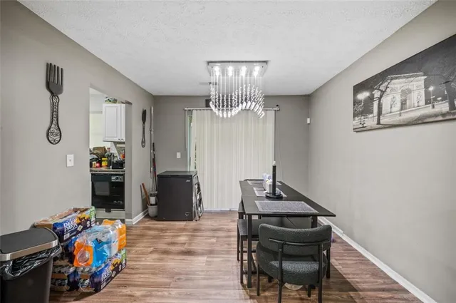 a view of a workspace with furniture and wooden floor