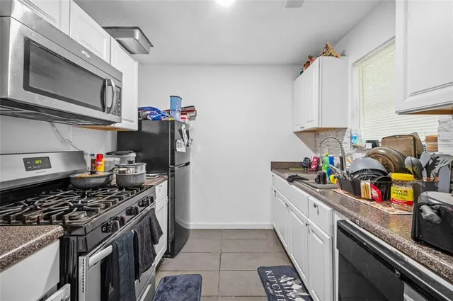 a kitchen with stainless steel appliances granite countertop a stove and a sink