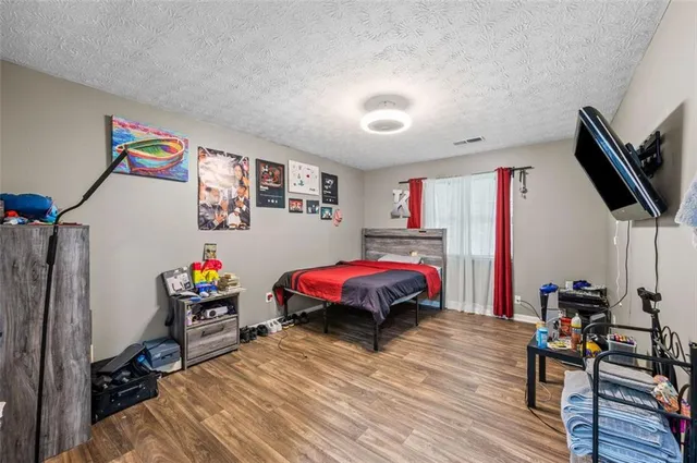 a bedroom with furniture and a flat screen tv