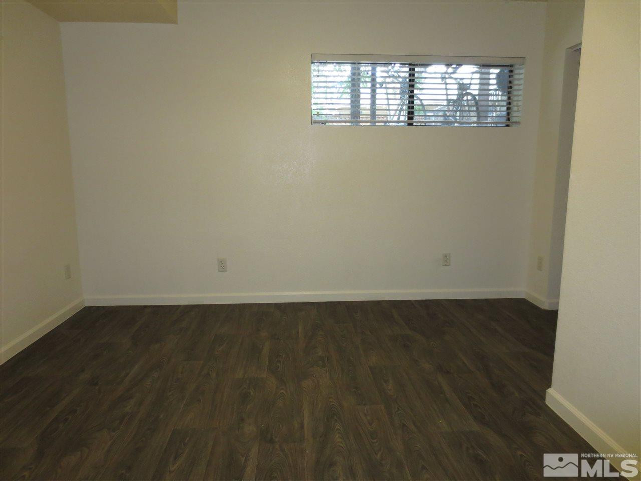 1045 Litch Court Reno, NV 89509 - Photo 4 of 18 an empty room with wooden floor and windows