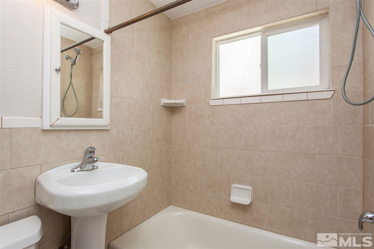 1045 Litch Court Reno, NV 89509 - Photo 6 of 18 a bathroom with a sink a toilet and a mirror